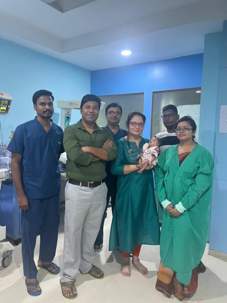 Dr.Nicola and her team with one of babies and family