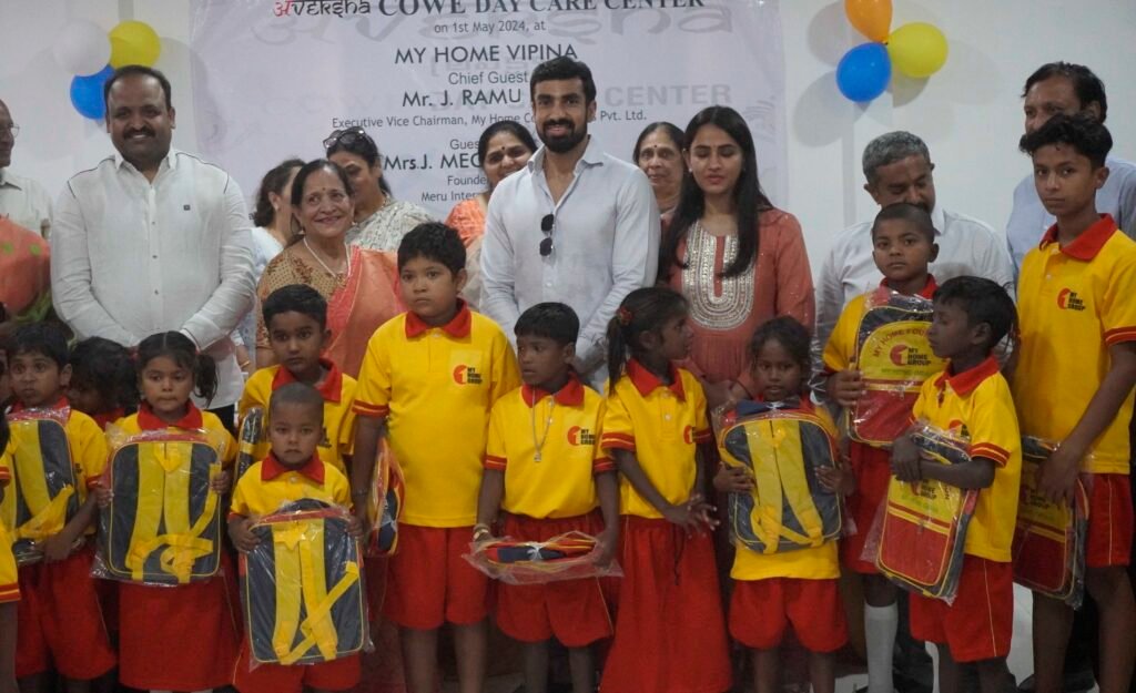 J RAMU AND J MEGHANA SEEN GIVING AWAY BAGS TO CONSTRUCITON WORKWRS CHILDREN AT THE INAUGURATION OF A DAY CARE CENTER FOR COSTRUCTION WORKERS AT MY HOME VIPINA PIC 2